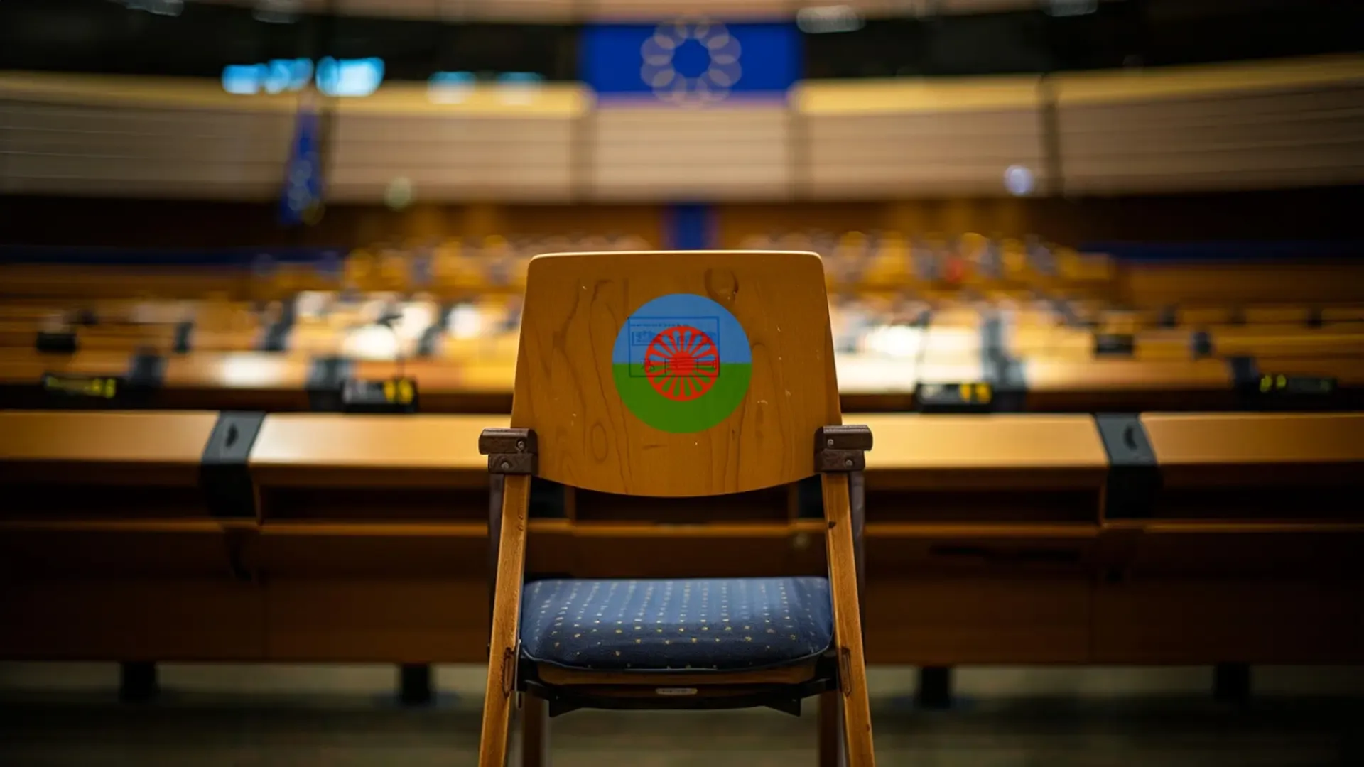 Empty chair with flag in European Parliament chamber.